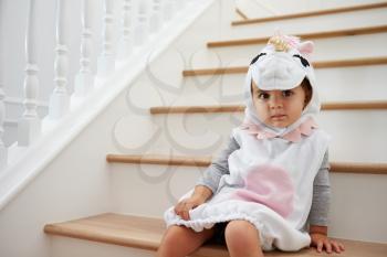 Child Dressed Up As Pony Playing Game On Stairs