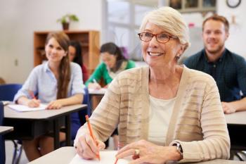 Happy senior woman at an adult education class looking up