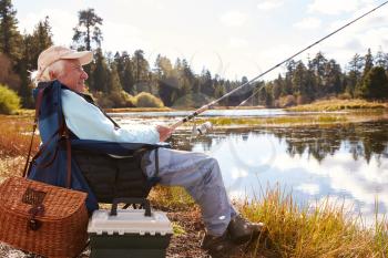 Senior man fishing in a lake, Big Bear, California, close-up