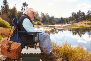 Senior man fishing in a lake, Big Bear, California, close-up