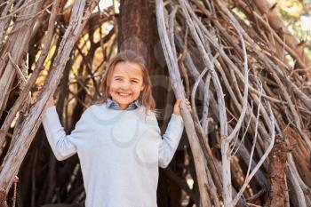 Portrait Of Girl Playing In Forest Camp