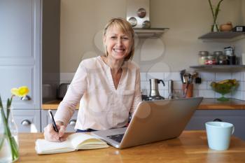 Portrait Of Woman Working From Home On Laptop In Apartment