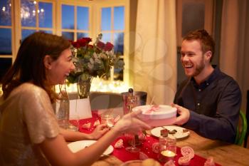 Man Gives Woman Gift At Romantic Valentines Day Meal