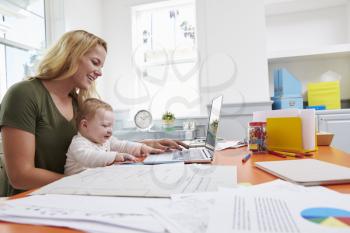 Busy Mother With Baby Running Business From Home