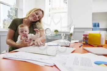 Busy Mother With Baby Running Business From Home