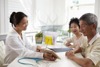 Senior Couple Meeting With Doctor In Office