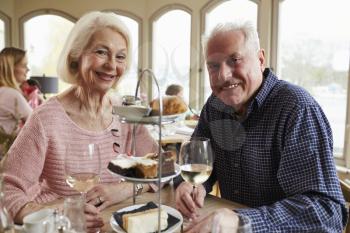 Senior Couple Enjoying Afternoon Tea In Restaurant Together
