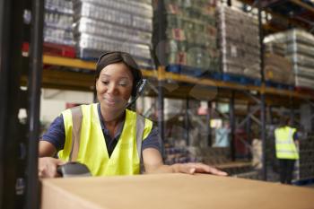 Woman using a barcode reader in a distribution warehouse