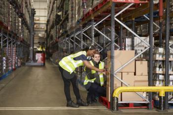 Staff identifying boxes in a distribution warehouse