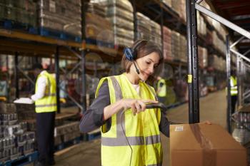 Woman using a barcode reader in a distribution warehouse