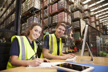 Staff in the office of a distribution warehouse, to camera
