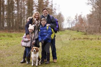 Family and dog in the countryside, full length portrait