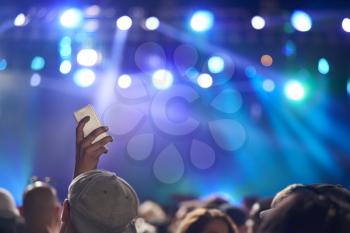 Fan Taking Photo On Mobile Phone At Music Festival