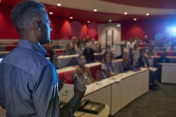 Man lecturing students in a university lecture theatre