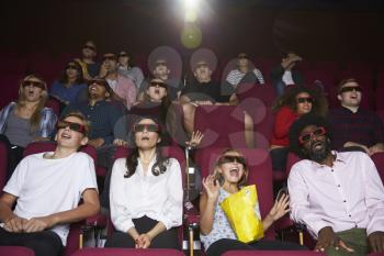 Audience In Cinema Wearing 3D Glasses Watching Horror Film