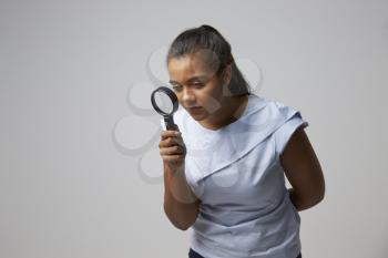 Portrait Of Female Criminologist With Magnifying Glass