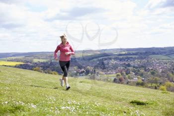Mature Woman Jogging In Countryside