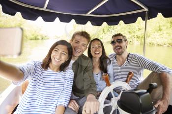 Friends Taking Selfie During Boat Ride On River Together