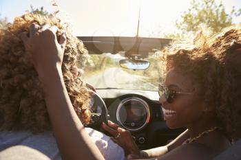 Woman embraces her partner as he drives, close up, Ibiza