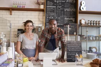 Mixed race couple behind counter at a coffee shop, close up