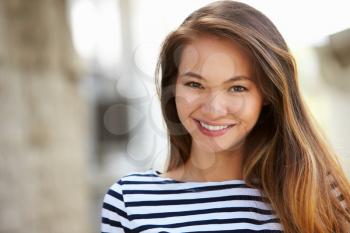 Outdoor Portrait Of Attractive Young Woman Smiling At Camera