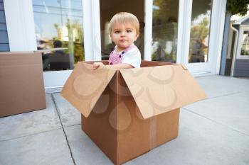 Little Boy Playing Inside Moving In Box
