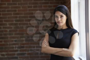 Head And Shoulders Portrait Of Young Businesswoman In Office