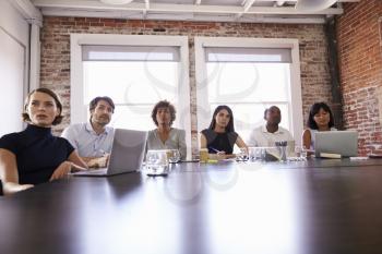 Businesspeople Listening To Presentation In Boardroom