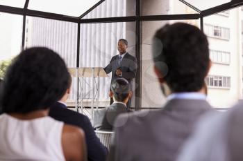 Black businessman presenting business seminar to an audience