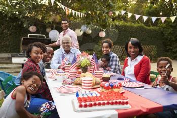 Multi generation black family having a 4th July garden party