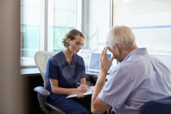 Doctor In Consultation With Depressed Male Patient