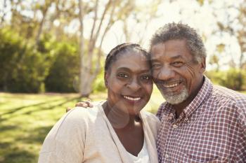 Outdoor Head And Shoulders Portrait Of Mature Couple In Park