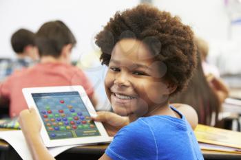 Pupil In Class Playing a Game on a Tablet
