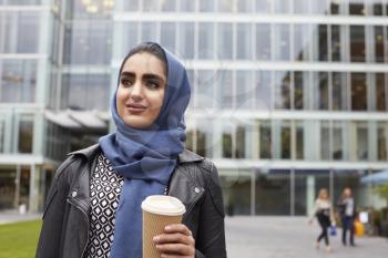 British Muslim Businesswoman With Coffee Outside Office