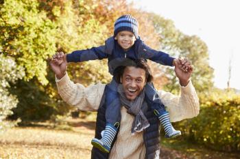 Portrait Of Walk With Father Carrying Son On Shoulders