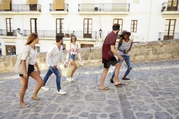 Young adult friends on holiday walking in Ibiza, Spain