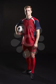 Portrait Of Professional Soccer Player With Ball In Studio