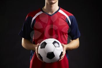 Close Up Of Professional Soccer Player With Ball In Studio