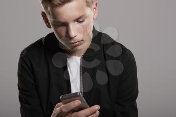 White teenage boy using mobile phone, waist up, close up