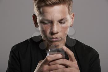 White teenage boy using mobile phone, head and shoulders