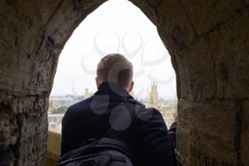 Rear View Of Tourist Looking Out Over View Of Oxford Skyline
