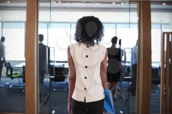 Rear View Of Businesswoman Entering Boardroom For Meeting