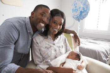 Portrait Of Parents Home from Hospital With Newborn Baby