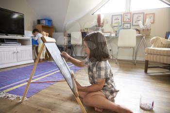 Girl Drawing On Chalkboard In Playroom