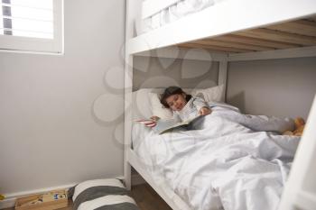 Girl Reading Story In Bunk Bed At Bedtime