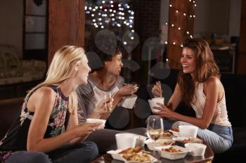 Three female friends hang out eating a Chinese take-away