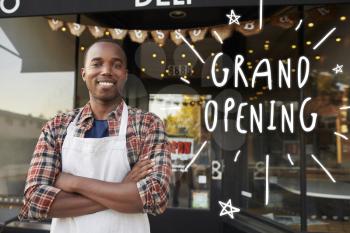 Black male business owner outside coffee shop grand opening
