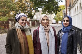 Portrait Of Muslim Female Friends In Urban Environment