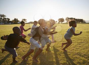 Elementary school kids running together in an open field