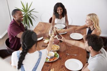 Overhead View Of Friends Enjoying Dinner Party At Home Together
